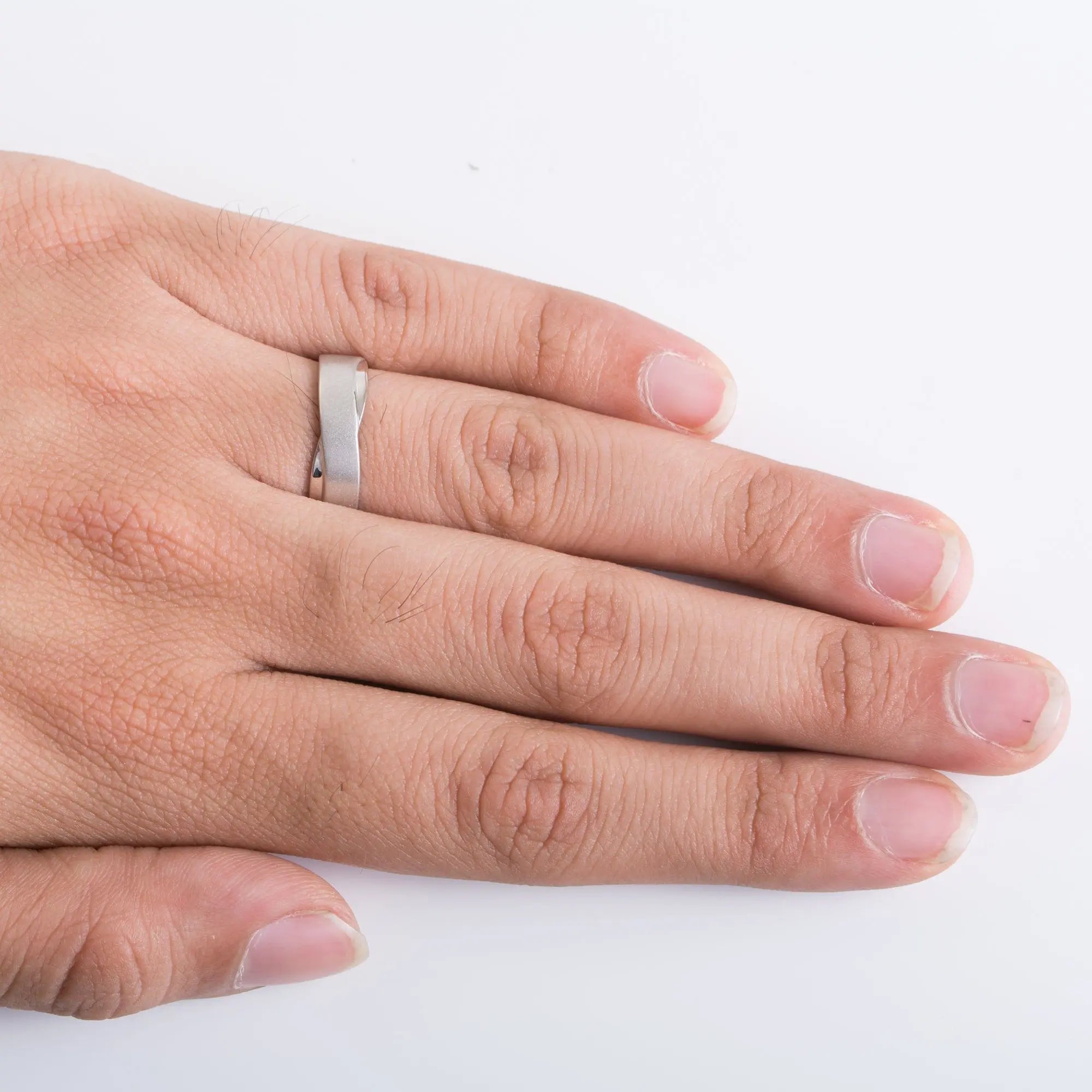 Finger Shot of Plain Platinum Ring with a Twist for Men. This view shows how the platinum ring looks when worn by men.