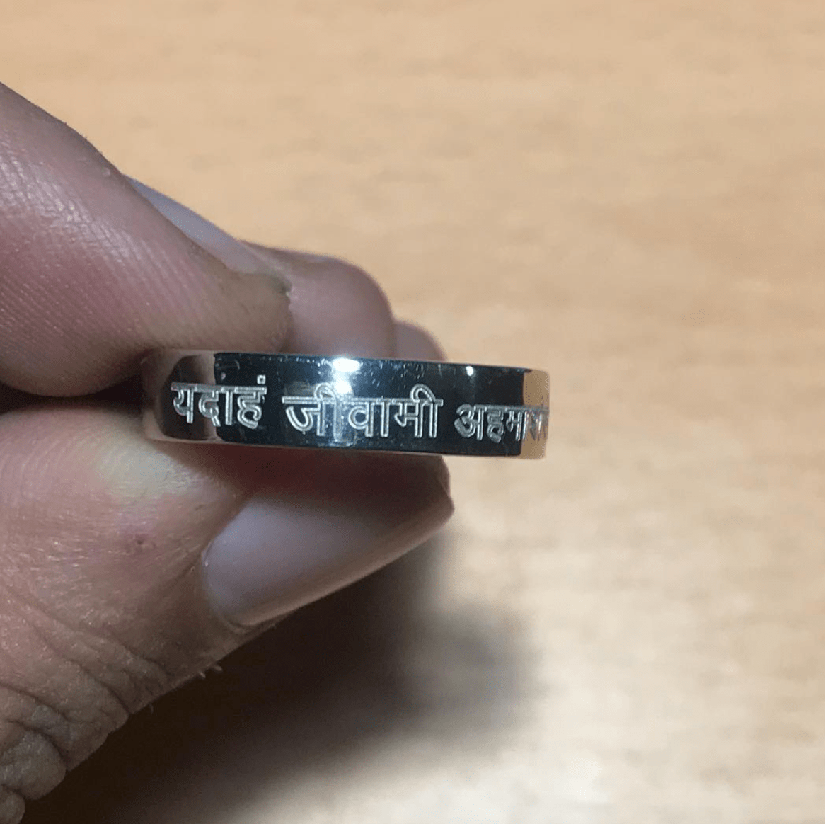 Plain 5mm Platinum Ring Engraved with a Hindi / Sanskrit Shlok on Life. Actual photo of the ring as taken from a mobile. Crafted by Jewelove with Love in India. Design JL PT 545